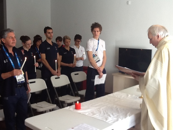 Don Lusek officiates the first Olympic Mass at the Village. "Work and sacrifice in order to see the light of success"